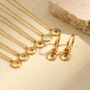 Macro detail of 18K gold plated birthstone necklaces and earrings in various colors