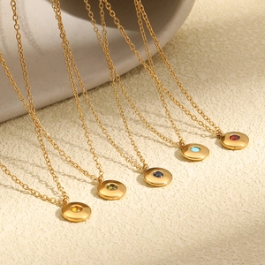 Close-up of minimalist 18K gold plated stainless steel necklaces with birthstones