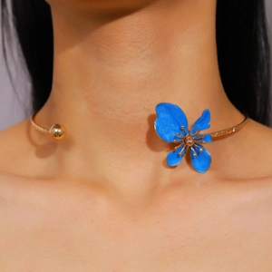 Close-up of blue enamel flower choker necklace on model's neck for elegant holiday style