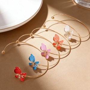 Detailed macro view of colorful dripping oil flower petals on gold open chokers.