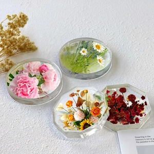 Set of four resin coasters with preserved flowers in circular and octagonal shapes
