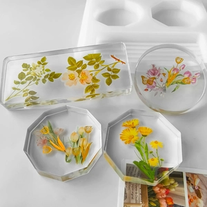 DIY crystal resin coasters kit with dried flowers and white silicone molds for crafts