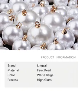 Detail of high-gloss white and beige imitation pearl charms with gold metal rings