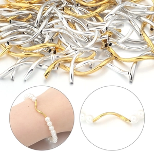 Detailed view of curved gold and silver metal tube spacer beads for DIY jewelry making