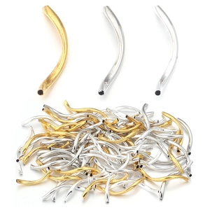 Detailed view of polished curved metal noodle beads for DIY bracelet and jewelry making