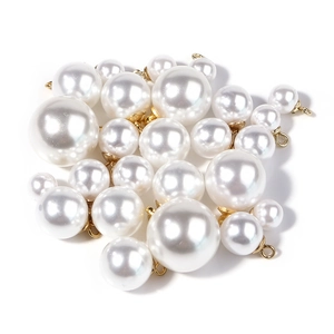 Polished faux pearl pendants with gold metal bases and loops in various sizes