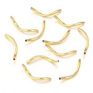 Close-up of golden curved tube beads for DIY jewelry making with smooth metallic finish