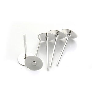 Macro view of five silver metal flat pad earring posts for DIY jewelry making