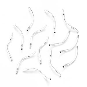 Close-up of polished silver curved metal tube beads for DIY bracelet jewelry making