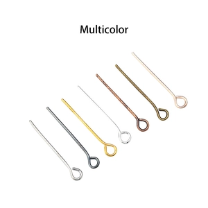 Close-up of multicolor metal eye pins for jewelry making in various metallic finishes