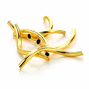 Macro shot of gold curved tube beads for DIY bracelet making on white background