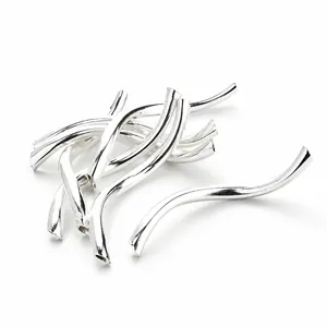 Macro shot of 2x25mm curved polished silver spacer beads for DIY jewelry making