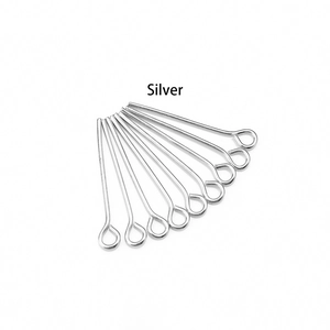 Close-up of polished silver eye pins for DIY jewelry making displayed on white background