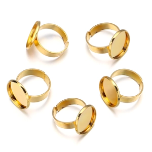 Close-up of five adjustable gold-plated round ring blanks for DIY jewelry making