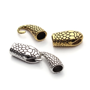 Detailed snake head jewelry clasp in gold and silver finish with fine scale texture