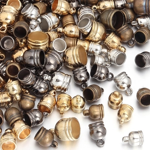 Macro shot of assorted metal bell end caps in gold and silver for DIY jewelry making