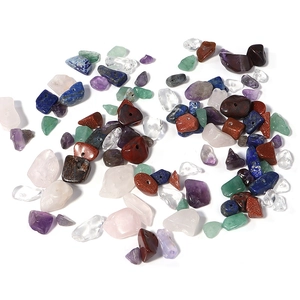 Macro detail of assorted natural stone chips with pre-drilled holes for DIY jewelry