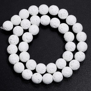 Macro shot of white lava stone round beads with porous texture for DIY jewelry