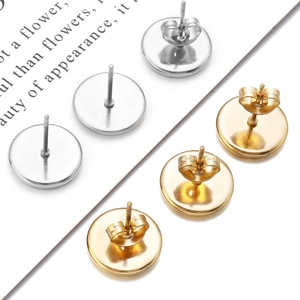 Close-up of gold and silver stainless steel flat round earring posts with butterfly backs