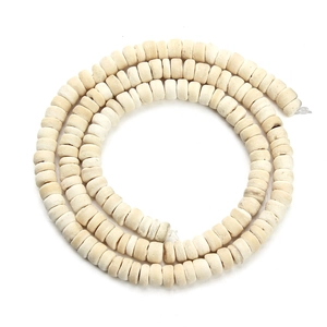 Close-up of ivory-colored flat round wooden beads strands for DIY jewelry making