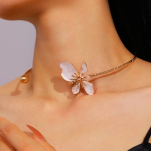 Detailed shot of retro floral petal choker necklace with gold stamen on model.