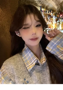 Detailed view of an exquisite sparkling zircon flower ear cuff on a female model