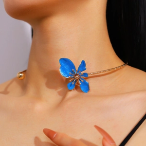 Detailed close-up showing the exquisite blue enamel flower on a gold-toned choker.
