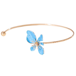 Close-up of retro gold-toned choker with detailed blue enamel flower petals.