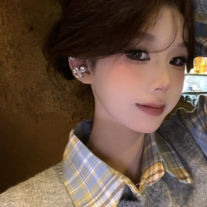 Close-up view of a sparkling zircon flower ear cuff worn gracefully on the ear bone.