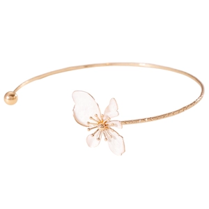 Detailed close-up of a vintage golden choker with a delicate white flower petal pendant.