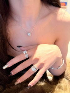 Detailed view of a silver minimalist open ring with water-drop and square zircons.