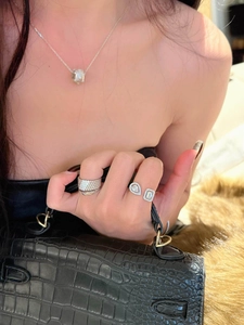 Elegant zircon open ring set featuring teardrop and square stones worn on model's hand