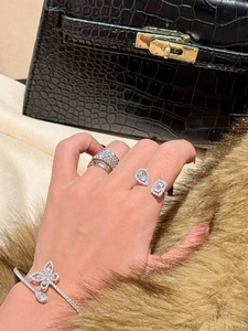 Close-up detail of high-quality zircon open ring with pear and emerald cut stones