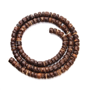 Detailed view of dark brown cylindrical wooden beads with natural grain for DIY jewelry