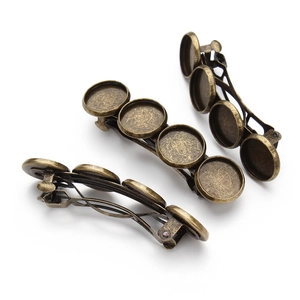 Detailed view of bronze hair clips with four bezel settings for DIY jewelry making