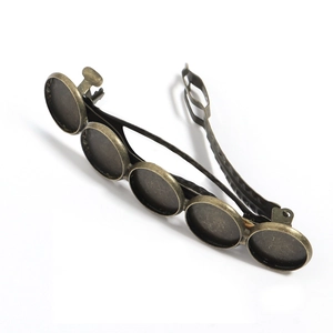 Detail of vintage bronze hair clip base with five round bezel trays for DIY jewelry craft