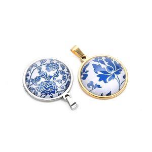 Detailed view of silver and gold pendants with blue and white floral porcelain patterns
