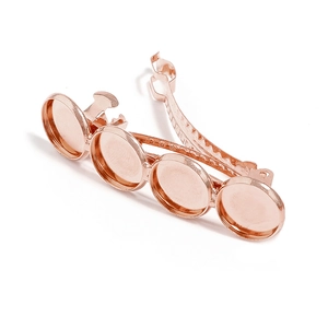 Close-up of rose gold hair clip base with four round bezels for DIY jewelry making