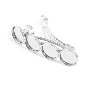 Detail of silver metal hair clips with four round DIY bezel settings for jewelry making