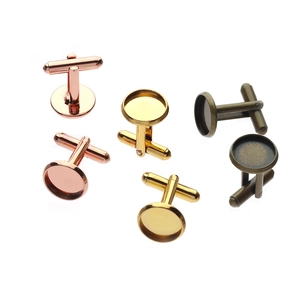 Flat lay of DIY round cufflink tray bases in rose gold, gold, and bronze metal finishes