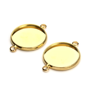 Macro view of gold round bezel tray connectors with double loops for DIY jewelry making