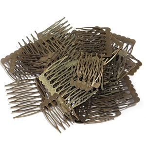 Macro view of vintage bronze metal hair combs for DIY jewelry making and handmade crafts