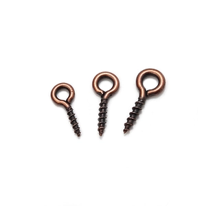Macro shot of bronze eye screw hooks in three sizes for DIY jewelry making and crafts