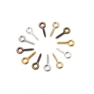 Detailed view of assorted metal eye pin screws for DIY jewelry making in various finishes