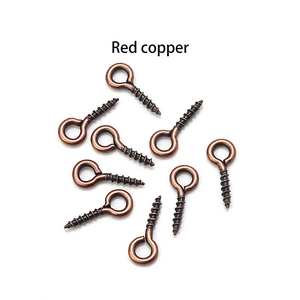 Macro detail of red copper eye pins with screw threads for DIY jewelry making