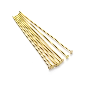 Macro shot of long gold-plated flat headpins for DIY jewelry making and beadwork