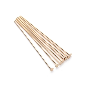 Macro view of rose gold flat head T-pins for DIY jewelry making and beading crafts