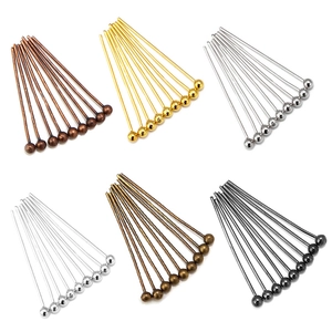 Assorted ball head pins for DIY jewelry making in six metallic finishes on white background