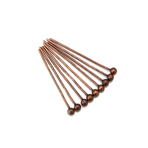 Macro shot of ten bronze ball head pins for DIY jewelry making with metallic texture
