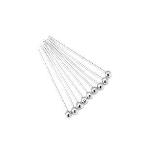 Close-up of silver ball head pins in polished copper for DIY jewelry making and beading